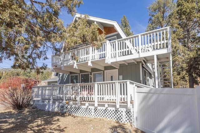 view of home's exterior featuring stairs and a deck