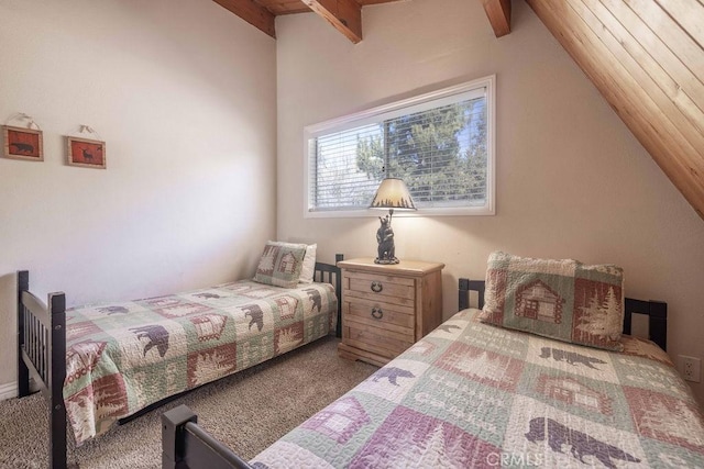 bedroom with vaulted ceiling with beams and carpet