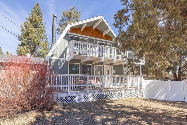 back of house featuring fence and a balcony