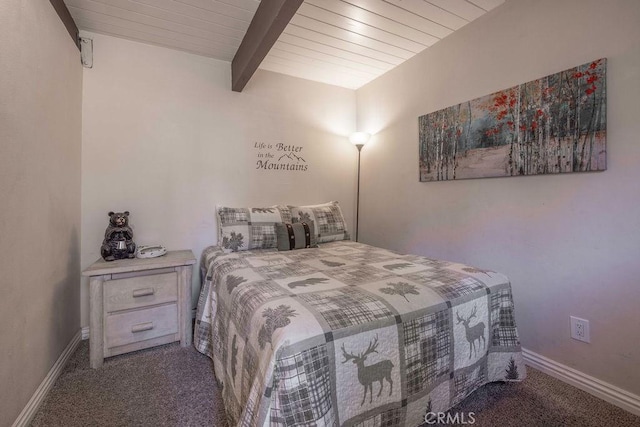 carpeted bedroom with beamed ceiling and baseboards