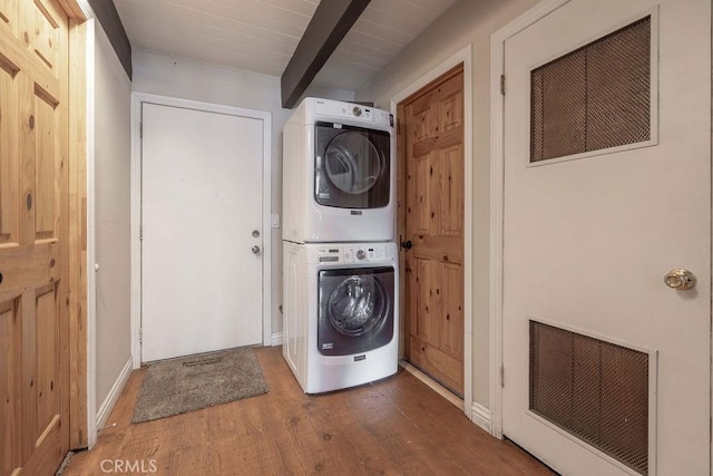 laundry area with visible vents, laundry area, wood finished floors, and stacked washer and clothes dryer