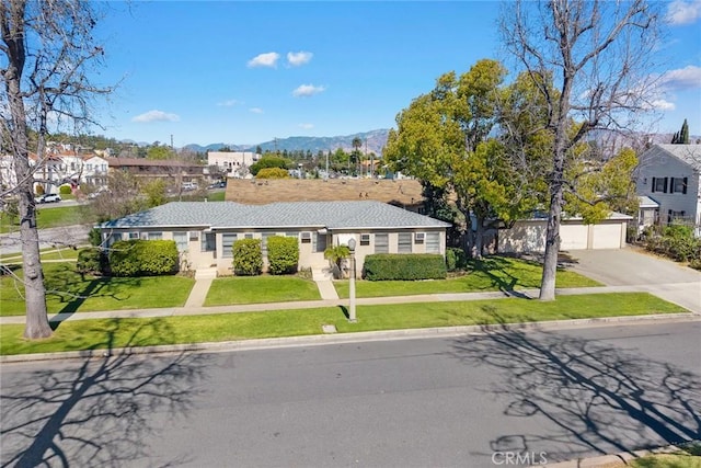 ranch-style home featuring a front yard, a residential view, and a mountain view