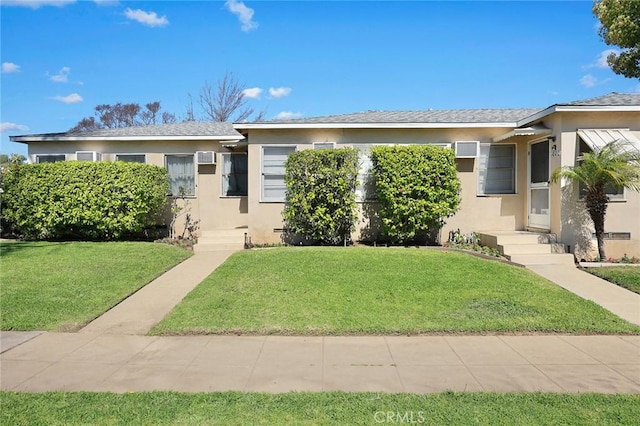 view of front facade featuring a front yard and stucco siding