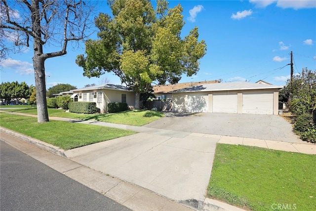 ranch-style home featuring an attached garage, driveway, and a front lawn