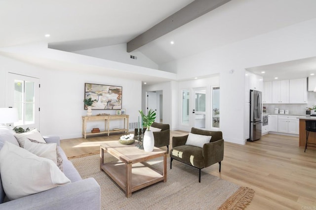 living area featuring vaulted ceiling with beams, light wood-style floors, baseboards, and recessed lighting