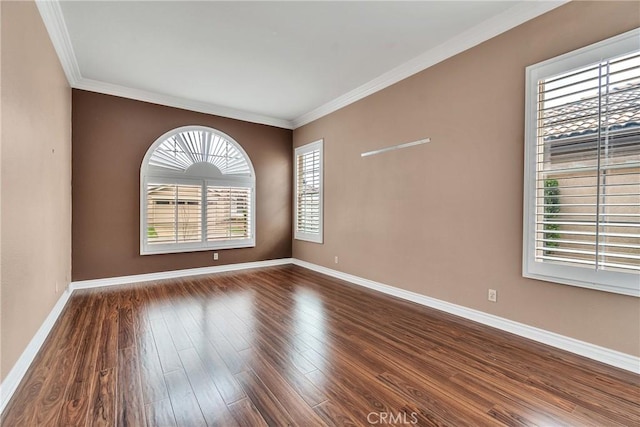 empty room featuring baseboards, dark wood-type flooring, and ornamental molding