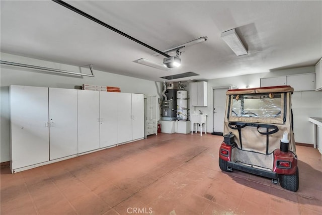 garage featuring a sink, heating unit, secured water heater, and a garage door opener