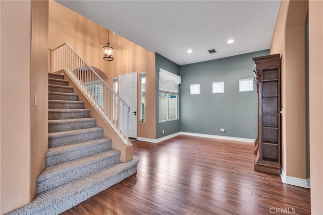 foyer entrance with recessed lighting, stairway, baseboards, and wood finished floors