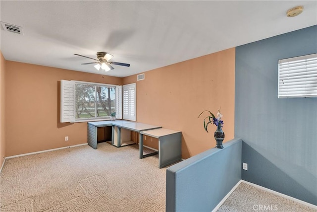 office featuring visible vents, baseboards, light carpet, and ceiling fan