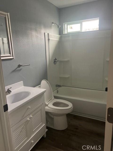 full bath featuring vanity, tub / shower combination, wood finished floors, and toilet