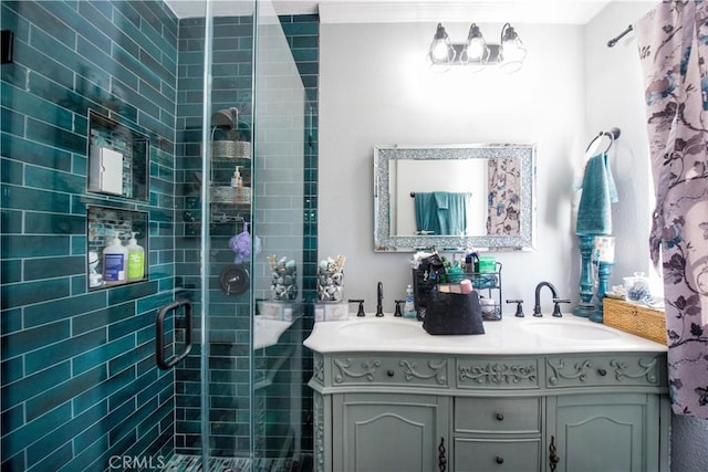 full bath featuring double vanity, a sink, and a shower stall