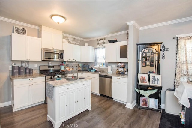 kitchen featuring appliances with stainless steel finishes, white cabinets, and dark wood-type flooring