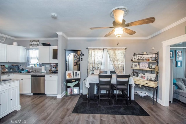 dining space featuring baseboards, dark wood finished floors, a ceiling fan, and crown molding