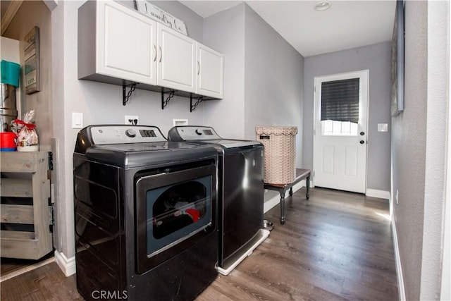 laundry area with cabinet space, washing machine and dryer, baseboards, and dark wood-type flooring