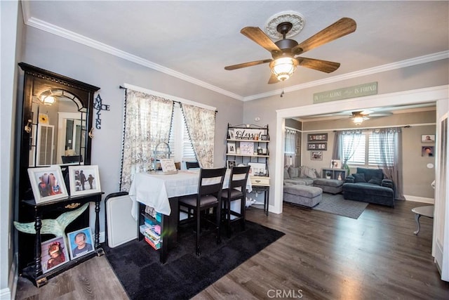 dining room with ceiling fan, ornamental molding, dark wood finished floors, and baseboards