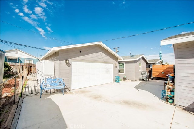 view of side of property featuring a garage and fence