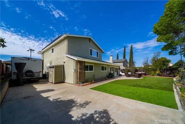 back of house featuring an outdoor hangout area, stucco siding, fence, and a lawn