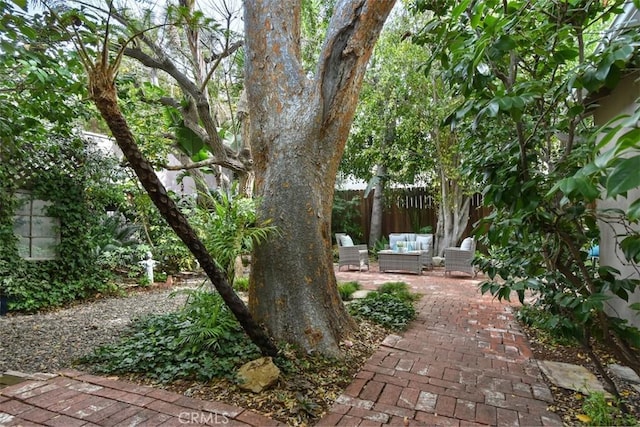 view of yard with fence, an outdoor hangout area, and a patio