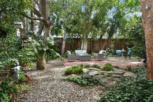 view of yard with a patio area, fence, and an outdoor living space