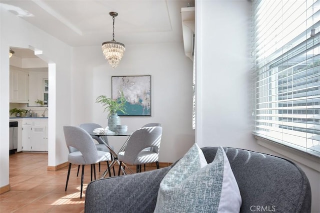 dining room with baseboards, an inviting chandelier, and light tile patterned floors