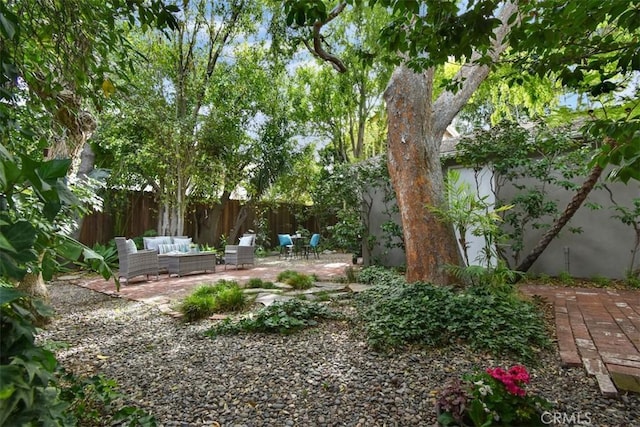 view of yard featuring outdoor lounge area, a patio area, and fence