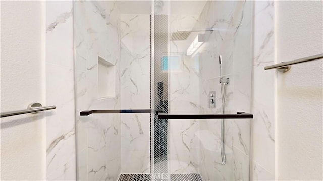 full bath featuring a marble finish shower