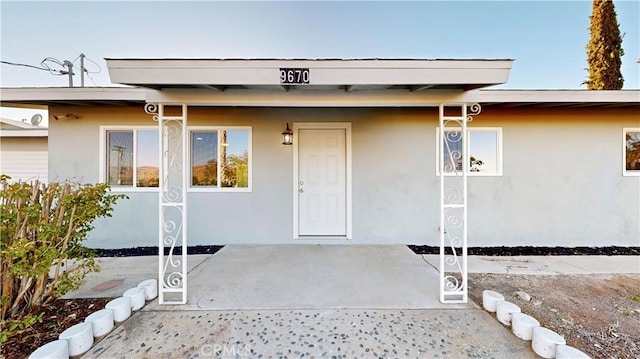 property entrance with stucco siding