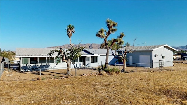 view of front of house with fence and a mountain view