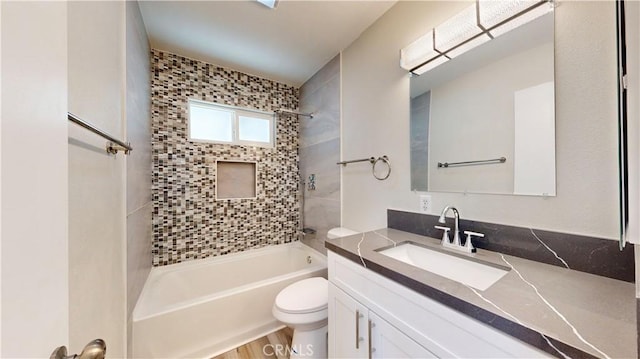 bathroom featuring tub / shower combination, vanity, and toilet