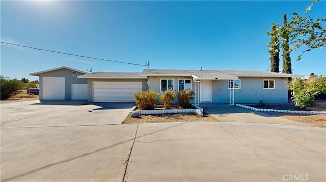 ranch-style house featuring driveway and an attached garage