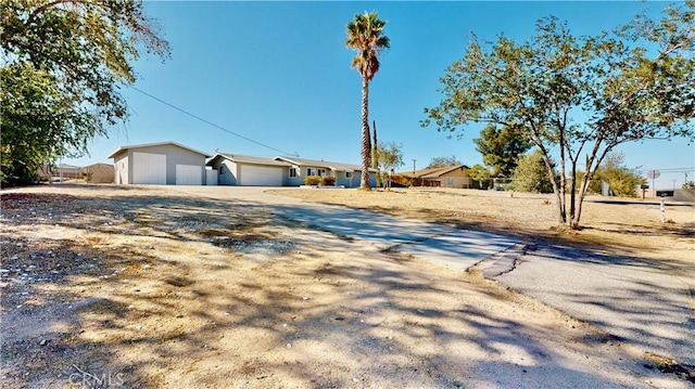 view of yard with driveway and an attached garage