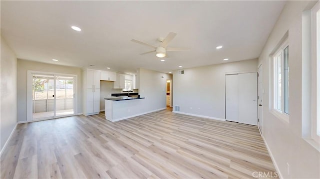 unfurnished living room with visible vents, baseboards, a ceiling fan, light wood-style flooring, and recessed lighting