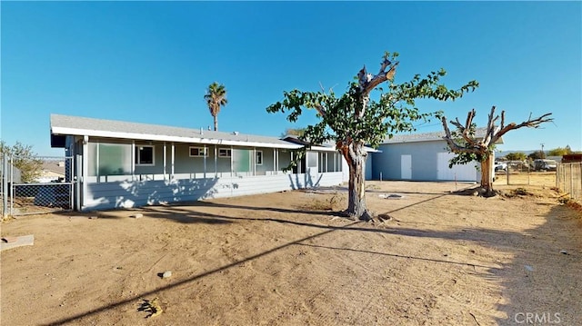 ranch-style house with fence