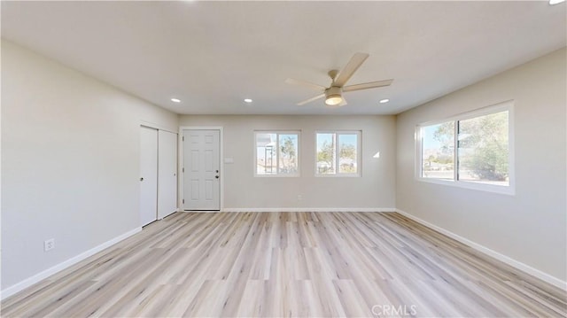 unfurnished room with a ceiling fan, recessed lighting, light wood-style flooring, and baseboards