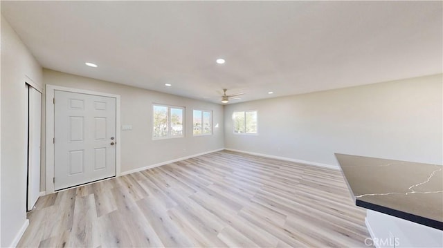 interior space featuring light wood-style flooring, baseboards, a ceiling fan, and recessed lighting