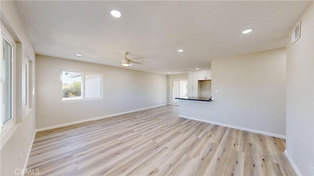 unfurnished room featuring baseboards, visible vents, light wood-style flooring, and recessed lighting