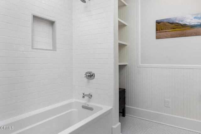 full bathroom featuring tile patterned flooring, tub / shower combination, and wainscoting