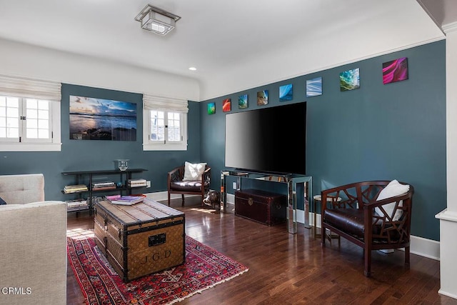 living area featuring baseboards, wood finished floors, and recessed lighting