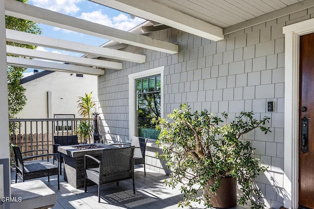 view of patio / terrace featuring an outdoor fire pit, a wooden deck, and a pergola