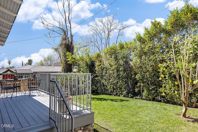 view of yard with outdoor dining area and a deck