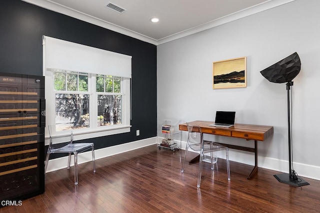 office space featuring crown molding, visible vents, wood finished floors, beverage cooler, and baseboards