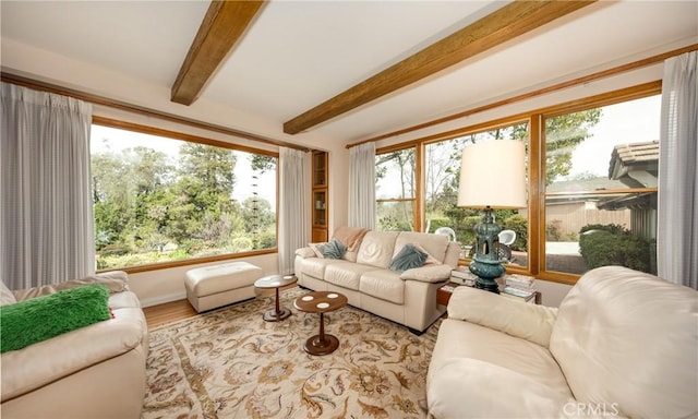 sunroom featuring beamed ceiling