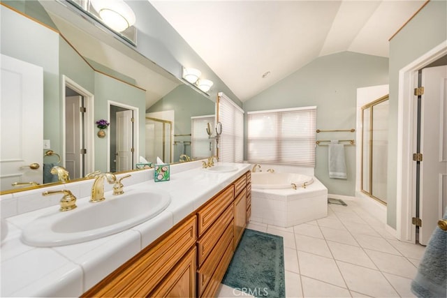 full bathroom with a garden tub, a stall shower, vaulted ceiling, a sink, and tile patterned floors