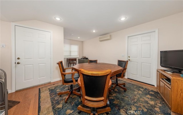 dining space featuring baseboards, a wall mounted air conditioner, wood finished floors, and recessed lighting