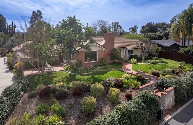 single story home with a patio area, a chimney, fence, and a front yard