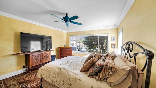 bedroom with a ceiling fan, multiple windows, crown molding, and baseboards