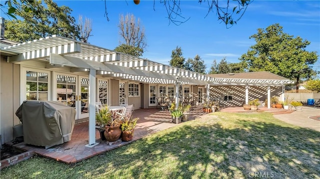 back of house with a lawn, a patio area, fence, and a pergola