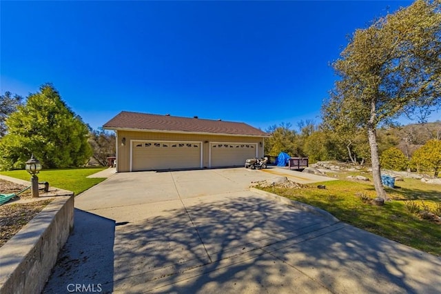 45544 Pine River Rd, Ahwahnee, CA 93601 - view of front of home featuring a garage, a front yard, and driveway