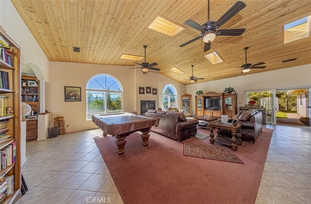 45544 Pine River Rd, Ahwahnee, CA 93601 - playroom featuring light tile patterned floors, high vaulted ceiling, a skylight, and wooden ceiling
