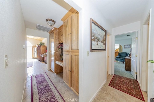 45544 Pine River Rd, Ahwahnee, CA 93601 - corridor featuring arched walkways, visible vents, baseboards, and light tile patterned flooring